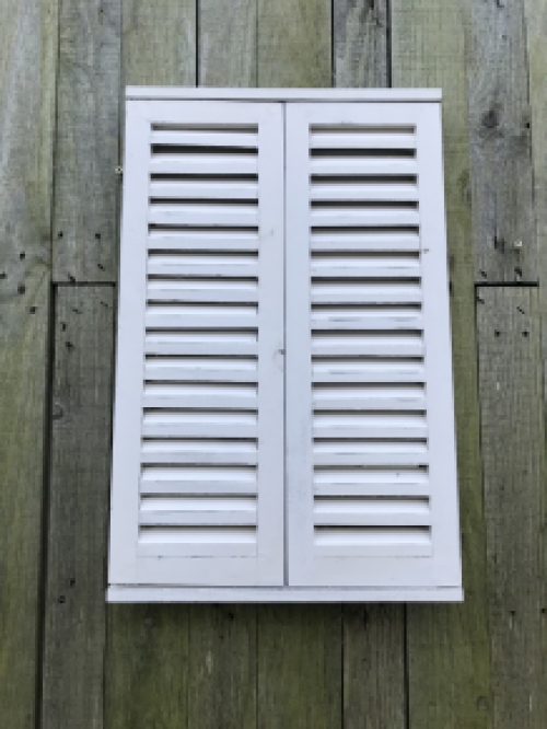  A mirror with hinged doors, made of wood