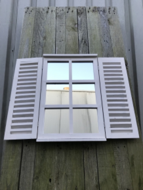  A mirror with hinged doors, made of wood