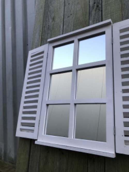  A mirror with hinged doors, made of wood