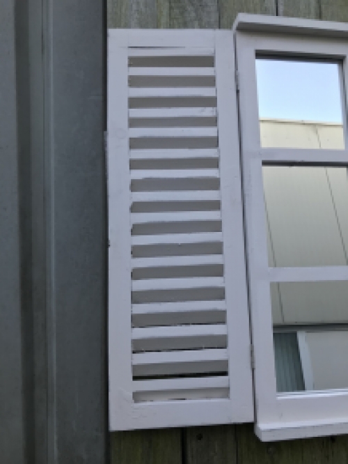  A mirror with hinged doors, made of wood